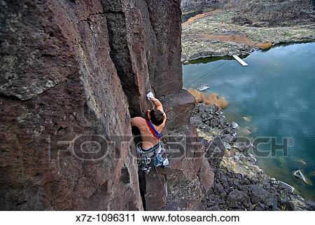 Man rock climbing a route called The Cutting Edge which is rated 5, 9 and located on The Tall Cliffs at Dierkes Lake Park in the Snake River Canyon near the city of Twin Falls in southern Idaho USA View Large Photo Image Stock Image - Man rock climbing a route called The Cutting Edge which is rated 5, 9 and located on The Tall Cliffs at Dierkes Lake Park in the Snake River Canyon near the city of Twin Falls in southern Idaho USA. Fotosearch