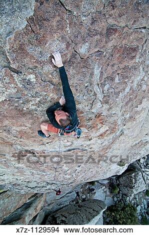 Man rock climbing a route named Shop And Compare which is rated 5, 10 and located on the Competition Wall at Castle Rocks State Park near the city of Almo in southern Idaho View Large Photo Image Picture - Man rock climbing a route named Shop And Compare which is rated 5, 10 and located on the Competition Wall at Castle Rocks State Park near the city of Almo in southern Idaho. Fotosearch