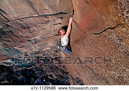 Man rock climbing Big Dude on The Tall Cliffs at Dierkes Lake Park near the city of Twin Falls in the Snake River Canyon of southern Idaho View Large Photo Image Stock Photograph - Man rock climbing Big Dude on The Tall Cliffs at Dierkes Lake Park near the city of Twin Falls in the Snake River Canyon of southern Idaho. Fotosearch