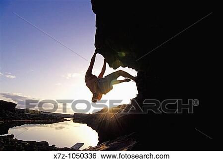 Man rock climbing bouldering The Overhang at Dierkes Lake Park in the Snake River Canyon near the city of Twin Falls Idaho USA View Large Photo Image Stock Photograph - Man rock climbing bouldering The Overhang at Dierkes Lake Park in the Snake River Canyon near the city of Twin Falls Idaho USA. Fotosearch