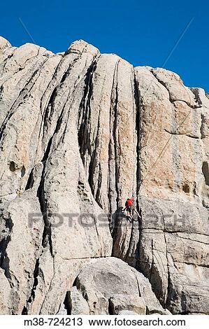Stock Image - Man rock climbing, City of Rocks, Idaho, USA. Fotosearch