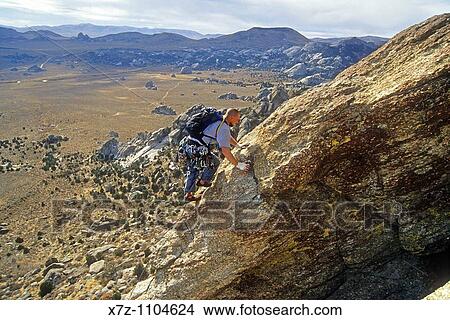 Man, rock climbing The South Buttress route high on Steinfells Dome in The City Of Rocks National Reserve near the town of Almo, Idaho View Large Photo Image Picture - Man, rock climbing The South Buttress route high on Steinfells Dome in The City Of Rocks National Reserve near the town of Almo, Idaho. Fotosearch