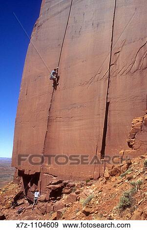 Man, rock climbing The Wiggins 1 route on the Cliffs Of Insanity in Indian Creek Canyon, Utah View Large Photo Image Stock Photo - Man, rock climbing The Wiggins 1 route on the Cliffs Of Insanity in Indian Creek Canyon, Utah. Fotosearch