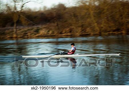 Man rowing along the river with a typical row boat in Oxford, UK View Large Photo Image Stock Photograph - Man rowing along the river with a typical row boat in Oxford, UK. Fotosearch