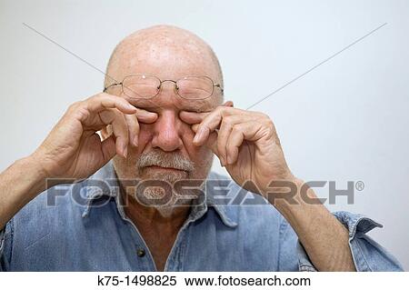 Man rubbing his eyes View Large Photo Image Stock Photography - Man rubbing his eyes. Fotosearch