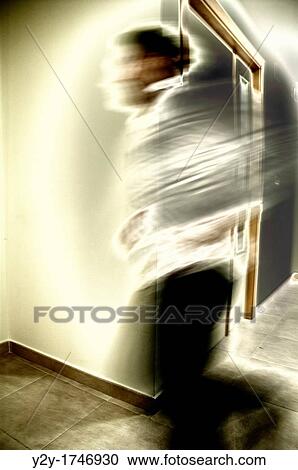 Stock Image - Man running at work. Fotosearch