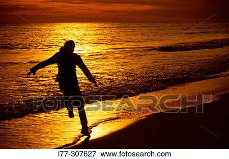 Man running on a beach View Large Photo Image Stock Photo - Man running on a beach. Fotosearch
