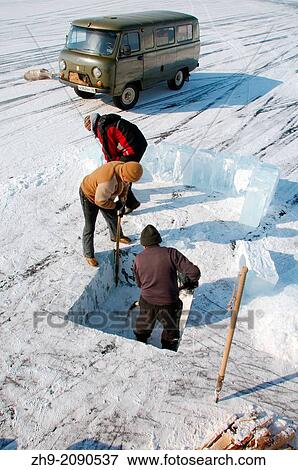 Man sawing an ice-hole for ice-diving, in Lake Baikal, Olkhon island, Siberia, Russia, Eurasia. View Large Photo Image Stock Photo - Man sawing an ice-hole for ice-diving, in Lake Baikal, Olkhon island, Siberia, Russia, Eurasia.. Fotosearch