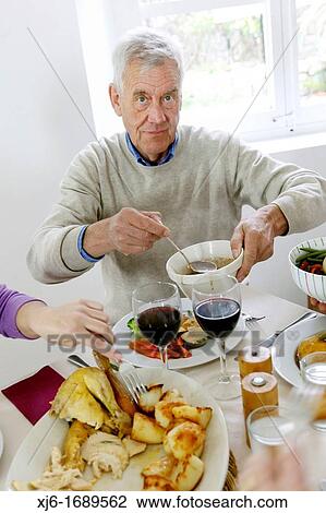 Man serving dinner View Large Photo Image Stock Image - Man serving dinner. Fotosearch