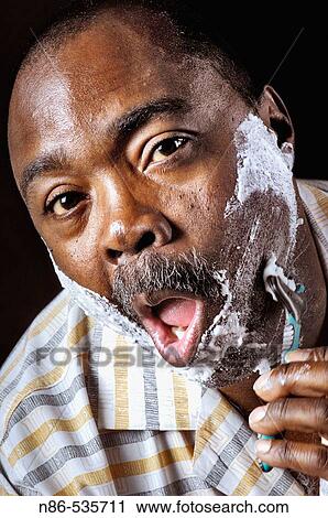 Man shaving face View Large Photo Image Stock Image - Man shaving face. Fotosearch