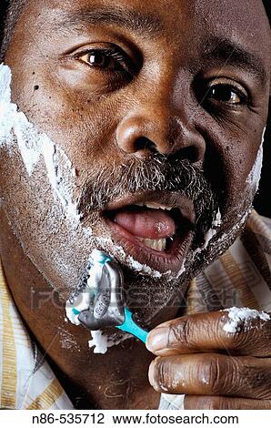 Man shaving face View Large Photo Image Stock Image - Man shaving face. Fotosearch