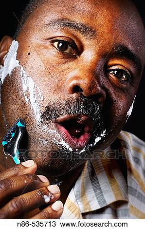 Man shaving face View Large Photo Image Stock Image - Man shaving face. Fotosearch