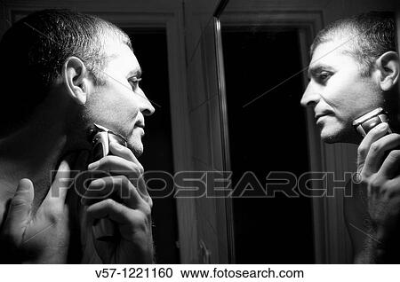 Man shaving his face in front of mirror. Black and white. View Large Photo Image Stock Image - Man shaving his face in front of mirror. Black and white.. Fotosearch