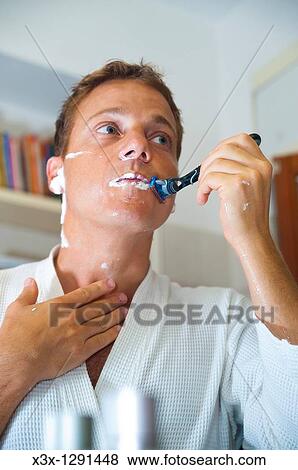 Man shaving in front of the mirror View Large Photo Image Stock Photo - Man shaving in front of the mirror. Fotosearch