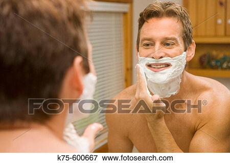 Man shaving in mirror View Large Photo Image Stock Photo - Man shaving in mirror. Fotosearch