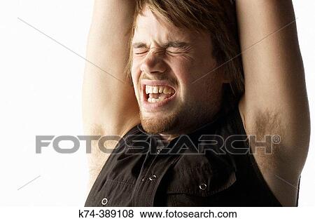 Stock Photo - Man Shouting With Arms Raised. Fotosearch