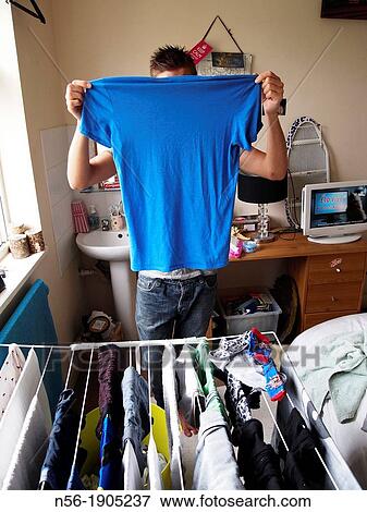 Man showing blue T-shirt View Large Photo Image Stock Photo - Man showing blue T-shirt. Fotosearch