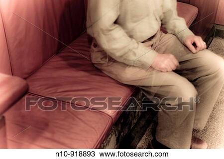 Man sitting at a booth in an office building lobby View Large Photo Image Stock Image - Man sitting at a booth in an office building lobby. Fotosearch