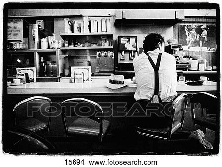 Man sitting at diner counter View Large Photo Image Picture - Man sitting at diner counter. Fotosearch