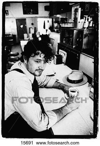 Man sitting at diner counter View Large Photo Image Stock Image - Man sitting at diner counter. Fotosearch