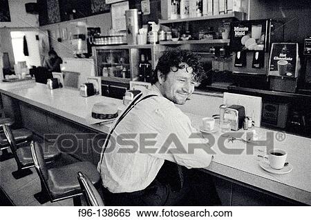 Man sitting at diner counter View Large Photo Image Stock Photography - Man sitting at diner counter. Fotosearch