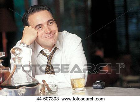 Man sitting in a bar smiling View Large Photo Image Stock Image - Man sitting in a bar smiling. Fotosearch