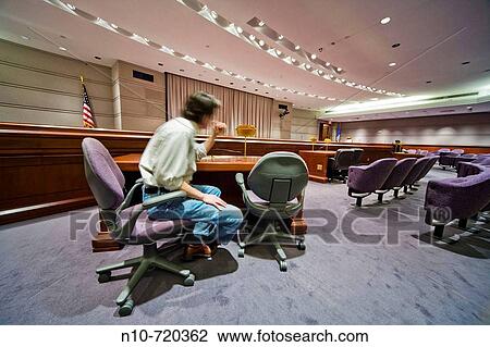 Man sitting in a chair in an otherwise empty conference room. View Large Photo Image Stock Image - Man sitting in a chair in an otherwise empty conference room.. Fotosearch