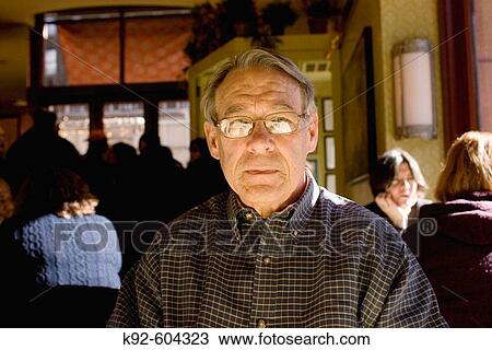 Stock Image - Man sitting in a restaurant.. Fotosearch