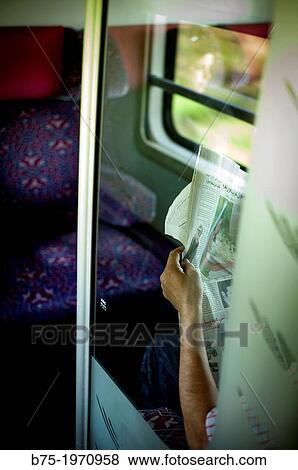 Man sitting in a train compartment, resting and reading the newspaper, Morocco, Africa View Large Photo Image Stock Photo - Man sitting in a train compartment, resting and reading the newspaper, Morocco, Africa. Fotosearch