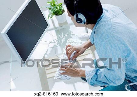 Man sitting in front of the computer View Large Photo Image Stock Photo - Man sitting in front of the computer. Fotosearch