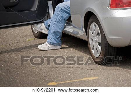 Man sitting in his car View Large Photo Image Stock Image - Man sitting in his car. Fotosearch