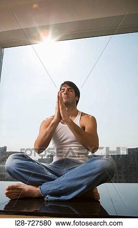 Man sitting in yoga position on floor View Large Photo Image Stock Image - Man sitting in yoga position on floor. Fotosearch