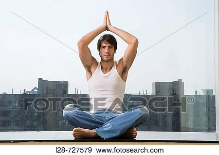 Man sitting in yoga position on floor View Large Photo Image Stock Photo - Man sitting in yoga position on floor. Fotosearch