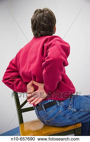 Man sitting on a chair, facing the wall. View Large Photo Image Stock Image - Man sitting on a chair, facing the wall.. Fotosearch