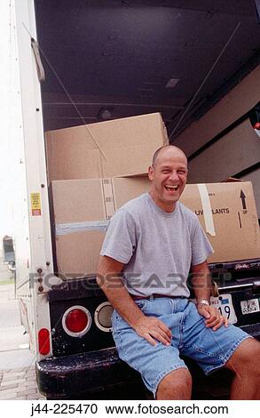 Man sitting on a moving truck deck laughing View Large Photo Image Stock Image - Man sitting on a moving truck deck laughing. Fotosearch