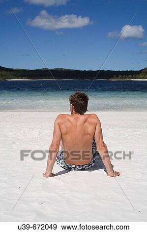 Man sitting on beach, seen from behind. Fraser Island, Australia View Large Photo Image Stock Photo - Man sitting on beach, seen from behind. Fraser Island, Australia. Fotosearch