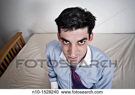 Man sitting on his bed View Large Photo Image Stock Image - Man sitting on his bed. Fotosearch