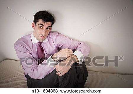 Man sitting on his bed View Large Photo Image Stock Photo - Man sitting on his bed. Fotosearch