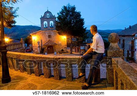 Man sitting on stone banister at evening. La Hiruela, Madrid province, Spain. View Large Photo Image Stock Image - Man sitting on stone banister at evening. La Hiruela, Madrid province, Spain.. Fotosearch