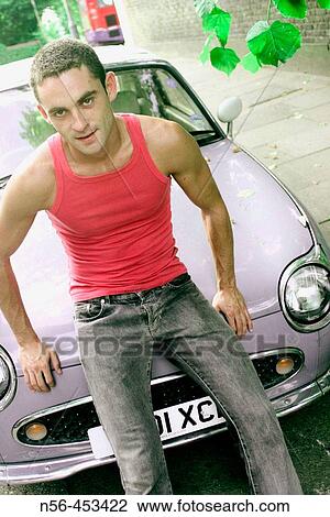 Stock Image - Man sitting on vintage car. Fotosearch