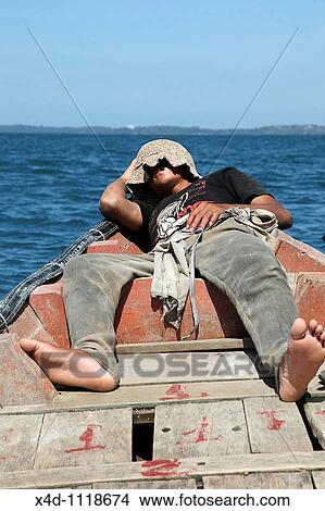 Man sleeping in boat, Cambodia View Large Photo Image Picture - Man sleeping in boat, Cambodia. Fotosearch