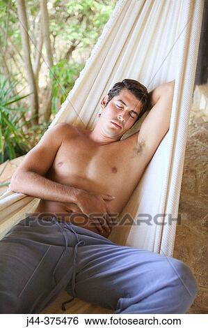 Man sleeping on a hammock View Large Photo Image Stock Photograph - Man sleeping on a hammock. Fotosearch