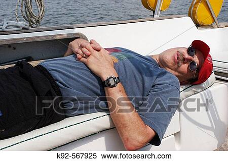 Man sleeping on a sailboat View Large Photo Image Stock Photography - Man sleeping on a sailboat. Fotosearch