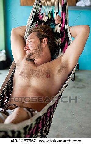 Man sleeping on hammock View Large Photo Image Stock Image - Man sleeping on hammock. Fotosearch