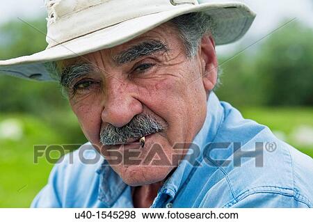 Stock Photo - Man smoking a rolled cigarette. Fotosearch