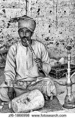 Man smoking water pipe in Cairo Egypt View Large Photo Image Stock Photo - Man smoking water pipe in Cairo Egypt. Fotosearch