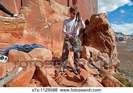 Man sorting gear to rock climb a route called Amaretto Corner on Super Crack Buttress at Indian Creek Canyon in southern Utah View Large Photo Image Stock Photo - Man sorting gear to rock climb a route called Amaretto Corner on Super Crack Buttress at Indian Creek Canyon in southern Utah. Fotosearch