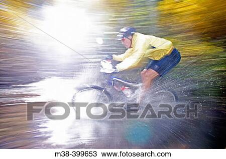 Man splashing through water on a mt. biking in Sun Valley, Idaho. USA View Large Photo Image Stock Image - Man splashing through water on a mt. biking in Sun Valley, Idaho. USA. Fotosearch