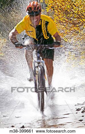 Man splashing through water on a mt. biking in Sun Valley, Idaho. USA View Large Photo Image Stock Image - Man splashing through water on a mt. biking in Sun Valley, Idaho. USA. Fotosearch