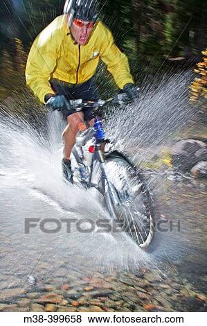 Man splashing through water on a mt. biking in Sun Valley, Idaho. USA View Large Photo Image Stock Photo - Man splashing through water on a mt. biking in Sun Valley, Idaho. USA. Fotosearch
